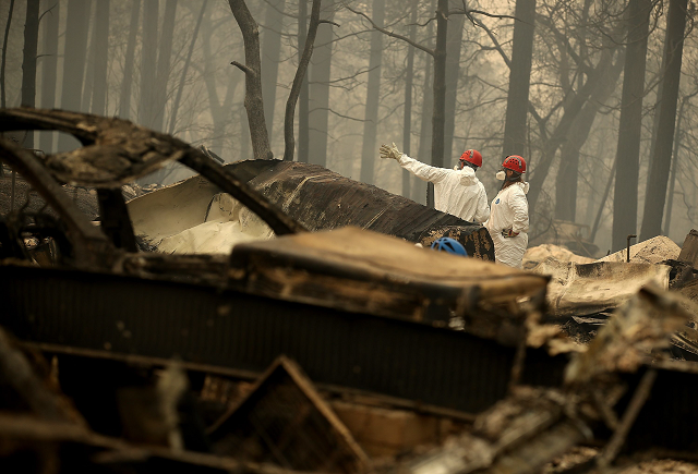 Rescue workers search for human remains at a mobile home park that was destroyed by the Camp Fire. PHOTO: AFP