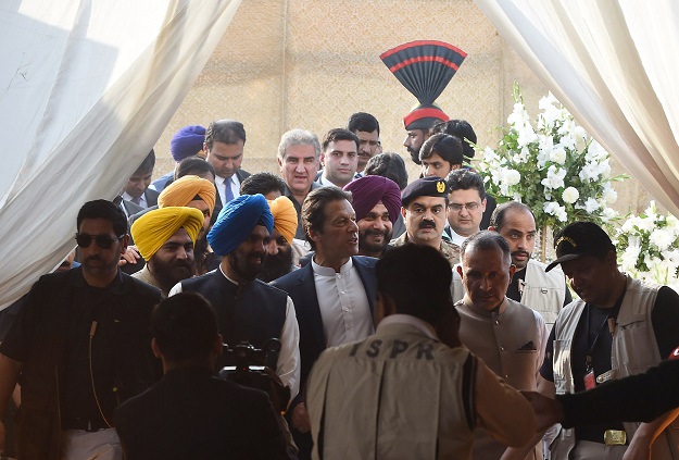 PM Imran Khan (C) arrives for the groundbreaking ceremony for the Kartarpur Corridor in Kartarpur on November 28, 2018. - Pakistan Prime Minister Imran Khan launched the groundbreaking ceremony of the religious corridor between India and Pakistan. PHOTO: AFP