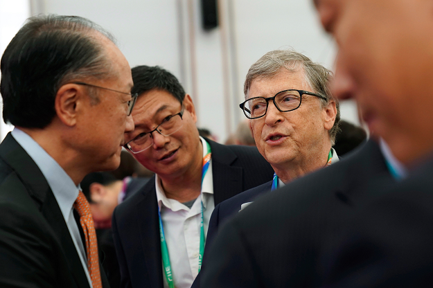 Microsoft founder Bill Gates (C) talks with World Bank President Jim Yong Kim (L) before the opening ceremony for the first China International Import Expo (CIIE) in Shanghai on November 5, 2018. PHOTO: AFP