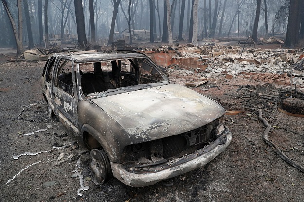 Burnt vehicles remain among other rubble from a fire-ravaged home on Busch Drive in Malibu, California on November 13, 2018 as residents remain under evacuation. At least 44 deaths have been reported so far from the late-season wildfires and with hundreds of people unaccounted for the toll is likely to rise,  as thousands of weary firefighters waged a pitched battle against the deadliest infernos in California's history. PHOTO: AFP