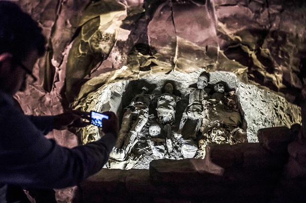 1.This picture taken on November 24, 2018 shows a man using a cell phone to take a picture of a group of mummies stacked together at the site of Tomb TT28, which was discovered by an Egyptian archaelogical mission at Al-Assasif necropolis on the west bank of the Nile north of the southern Egyptian city of Luxor. - Located between the royal tombs at the Valley of the Queens and the Valley of the Kings, the Al-Assasif necropolis is the burial site of nobles and senior officials close to the pharaohs. PHOTO: AFP