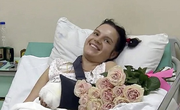 Margarita Grachyova who had her hands chopped off with an axe by her jealous husband has been pictured smiling and wriggling a finger after surgeons reattached one of her hands. PHOTO COURTESY: MAIL ONLINE