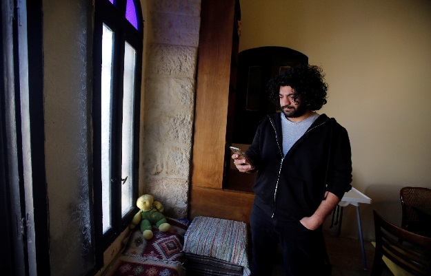 Palestinian musician Firas Harb uses Spotify app on his mobile phone in Beit Sahour, in the occupied West Bank. PHOTO REUTERS