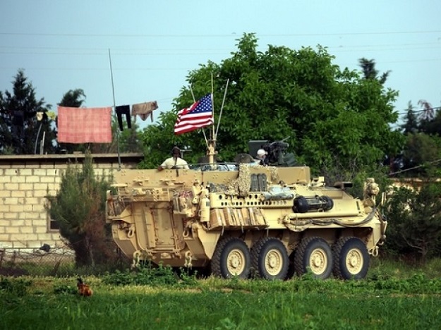 US forces, accompanied by Kurdish People's Protection Units (YPG) fighters, drive their armoured vehicles near the northern Syrian village of Darbasiyah, on the border with Turkey. PHOTO: AFP