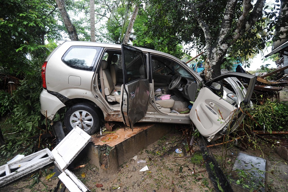 This picture shows a damaged car at the Mutiara Carita Cottages in Carita in Banten province. Photo: AFP