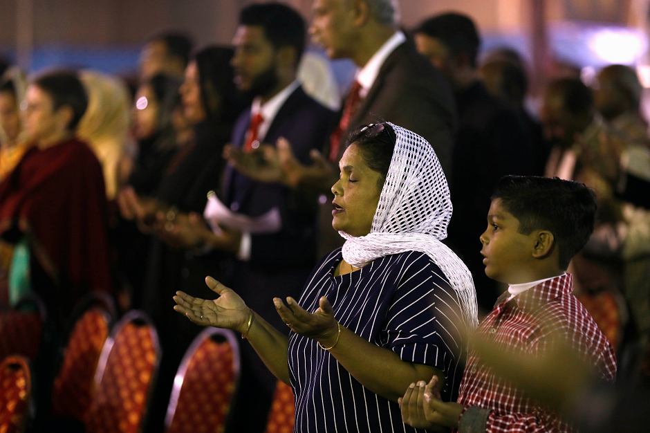  A mother and son pray during a Christmas Eve service at the St. PatrickÃs Cathedral in Karachi. PHOTO: REUTERS