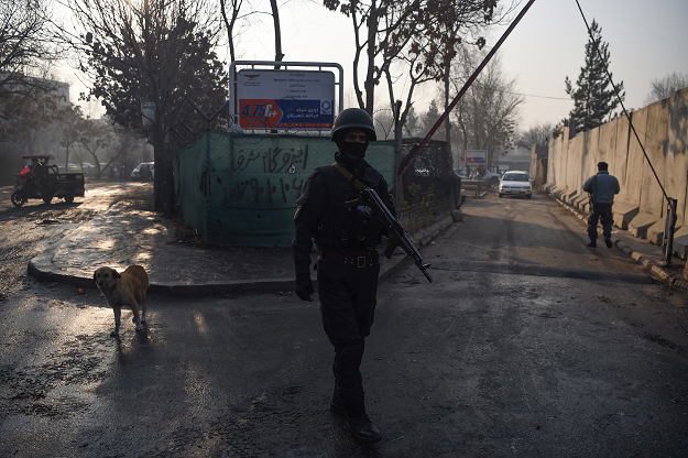  Afghan policeman stands guard near the entrance gate of the Ministry of Public Works. PHOTO: AFP