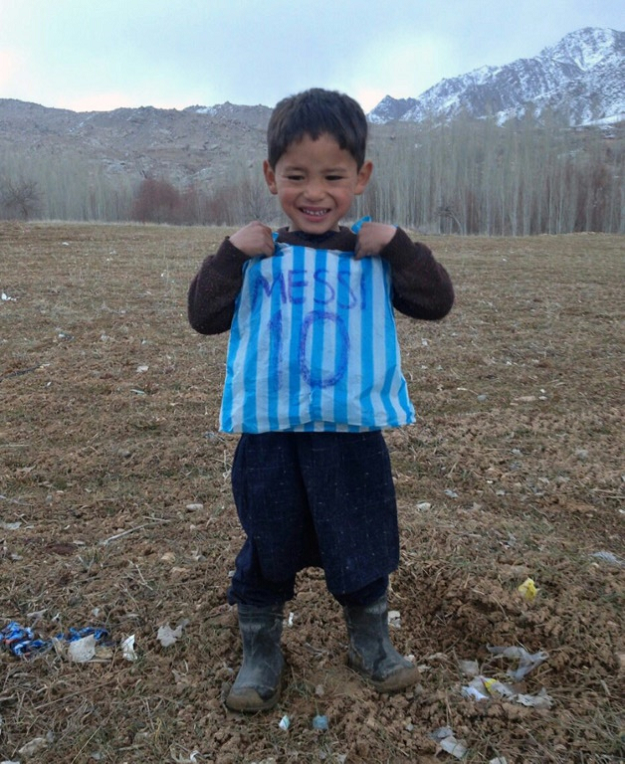Murtaza Ahmadi's brother made him a makeshift jersey out of a blue and white striped plastic bag, with Messi's name and famous number 10 written carefully on the back in felt-tip pen. PHOTO: AFP