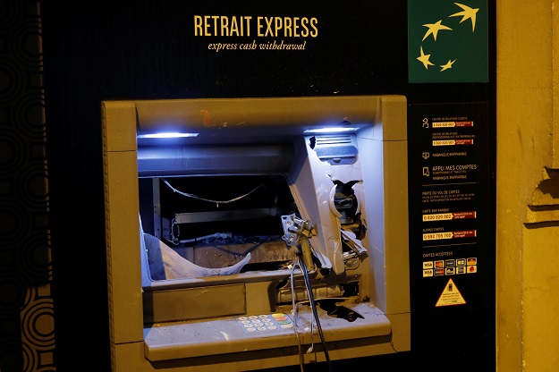4.A damaged bank cash machine of BNP Paribas bank is seen on avenue Kleber after clashes PHOTO: REUTERS