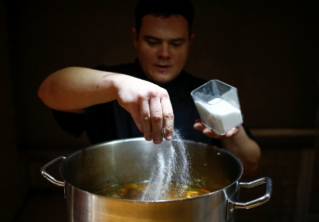 A chef of Caffe Italia restaurant cooks soup as part of a charity program to help homeless people in St. Petersburg, Russia. PHOTO: REUTERS