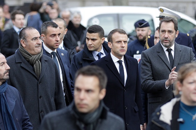 French President Emmanuel Macron flanked by ministers walks in a street of Paris on December 2, 2018, a day after clashes. PHOTO:AFP