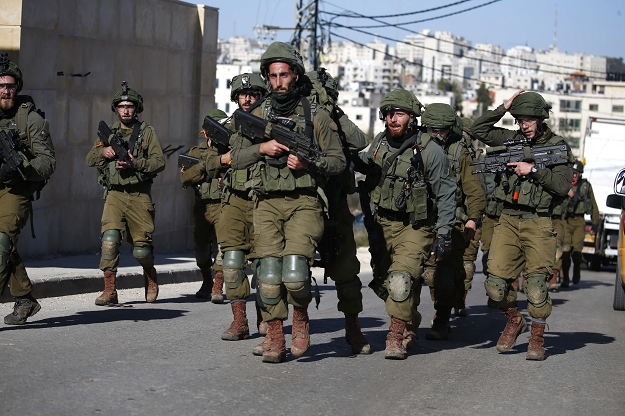 Israeli troops withdraw from Ramallah in the Israeli-occupied West Bank after blowing up a house belonging to a Palestinian accused of killing an Israeli soldier a few months ago,  on December 15, 2018. PHOTO: AFP