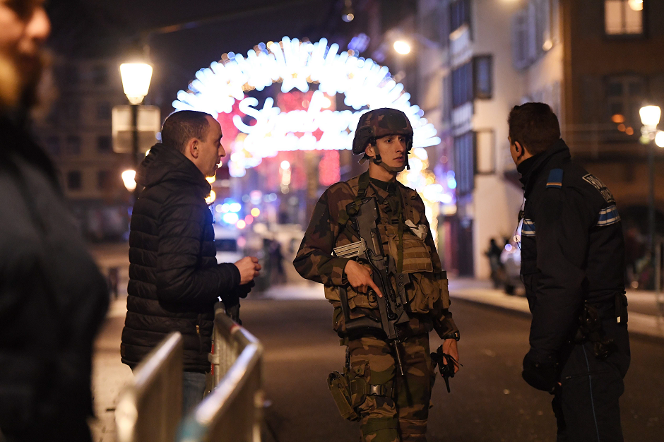 Policemen speak with a military in the streets of Strasbourg, eastern France, after a shooting breakout, on December 11, 2018. PHOTO: AFP