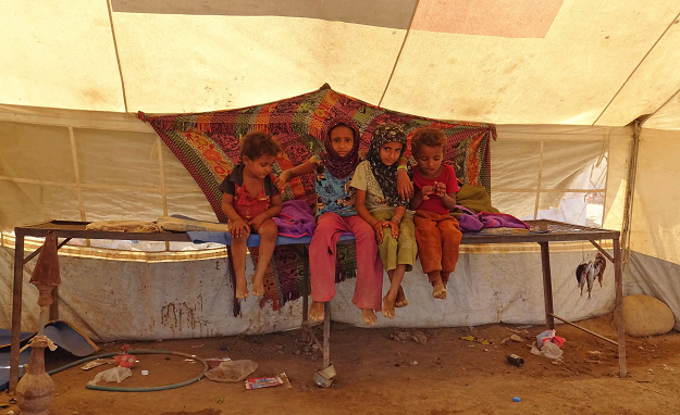 Yemeni children gather inside a tent at a camp for displaced people in the Khokha district of the western province of Hodeidah on December 12, 2018. PHOTO: AFP