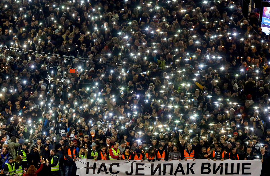 Anti-government protesters hold up their phones and candles and hold a banner in Cyrillic writing that reads 'Still there is more of us' as they arrive at the end of their silent march in memory of Serb politician Oliver Ivanovic in Belgrade on January 16, 2019. - A year after Serb politician Oliver Ivanovic was slain in a drive-by shooting in Kosovo, his unsolved murder continues to haunt this tense and crime-ridden corner of Europe, where the main suspect is still on the run. The 64-year-old was struck down by six bullets in January 2018 outside his party headquarters in the Kosovo city of Mitrovica, where the Ibar river draws a line between a mainly ethnic Albanian community in the south and Serbs in the north. PHOTO: AFP