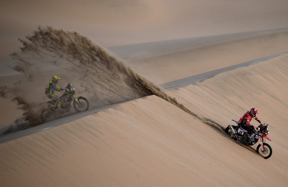 French biker Michael Metge (L) and Bolivia's Daniel Nosiglia Jager compete during Stage 9 of the Dakar 2019 in and around Pisco, Peru, on January 16, 2019. - French biker Michael Metge won the stage. PHOTO: AFP