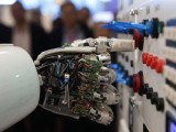 The hand of the humanoid robot controls a painting during a demonstration. PHOTO: REURERS