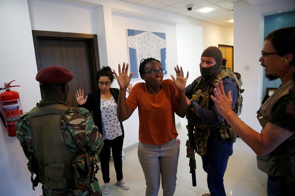 People are evacuated by a member of security forces at the scene where explosions and gunshots were heard at the Dusit hotel compound, in Nairobi, Kenya. PHOTO: REUTERS 