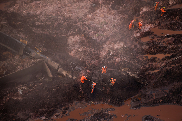 Rescuers work in the search for victims after the collapse of a dam. PHOTO: AFP