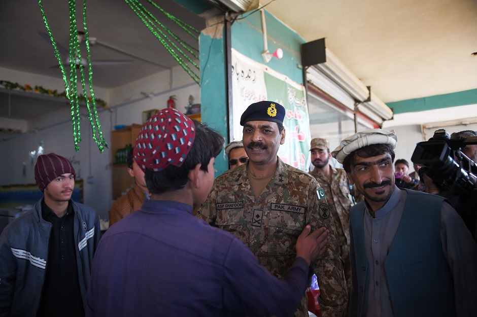Army spokesperson Major General Asif Ghafoor (C) greets with tribal peoples during his visit a market in Miran Shah, a town in North Waziristan, near the border between Pakistan and Afghanistan. PHOTO: AFP