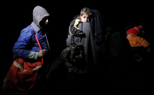 A woman and children in the eastern Syrian Deir Ezzor province on January 25, 2019, after fleeing the remaining pocket held by the Islamic State group. PHOTO: AFP