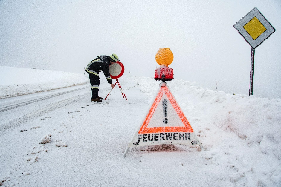 A fireman sets up a sign on a road blocked due to heavy snowfall on January 13, 2019 in Elisabethszell, southern Germany. PHOTO: AFP