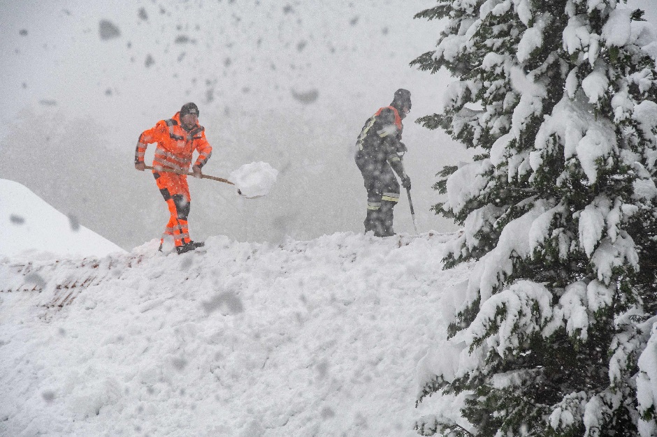 Men shovel snow from a roof in Elisabethszell, southern Germany. PHOTO: AFP