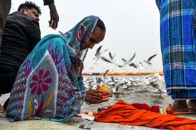 An Indian devotee prays after taking a dip on the Triveni Sangam banks, the confluence of the Ganges, Yamuna and mythical Saraswati rivers, at the Kumbh Mela festival in Allahabad. PHOTO: AFP