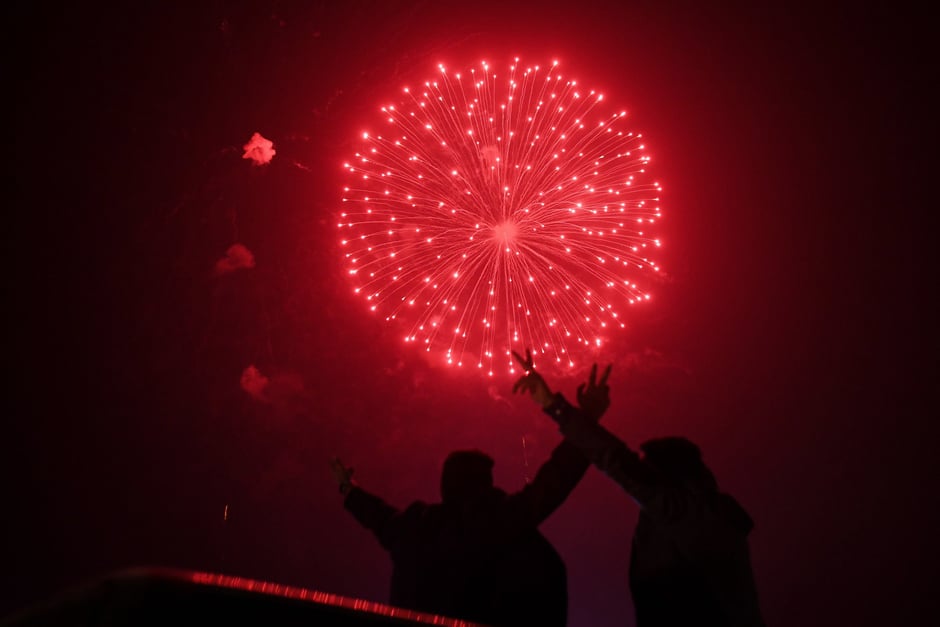 A man watches the fireworks display during the New Year celebrations in Karachi. PHOTO: AFP