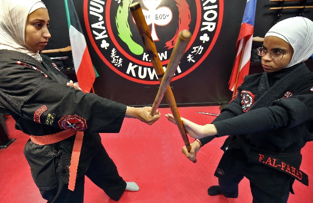 Kuwaiti Asma Hasnawi (L) and Fai al-Fahad, Kajukenbo hybrid martial art assistant-master, practise in a club in Kuwait City. PHOTO: AFP