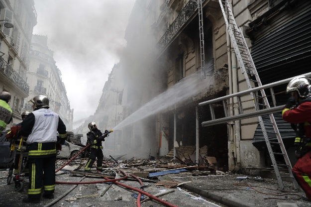 Emergency workers and firefighters intervene after the explosion of a bakery on the corner of the streets Saint-Cecile and Rue de Trevise in central Paris. PHOTO: AFP