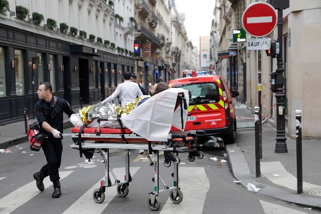 An injured person is evacuated by firefighters after the explosion of a bakery on the corner of the streets Saint-Cecile and Rue de Trevise in central Paris. PHOTO: AFP