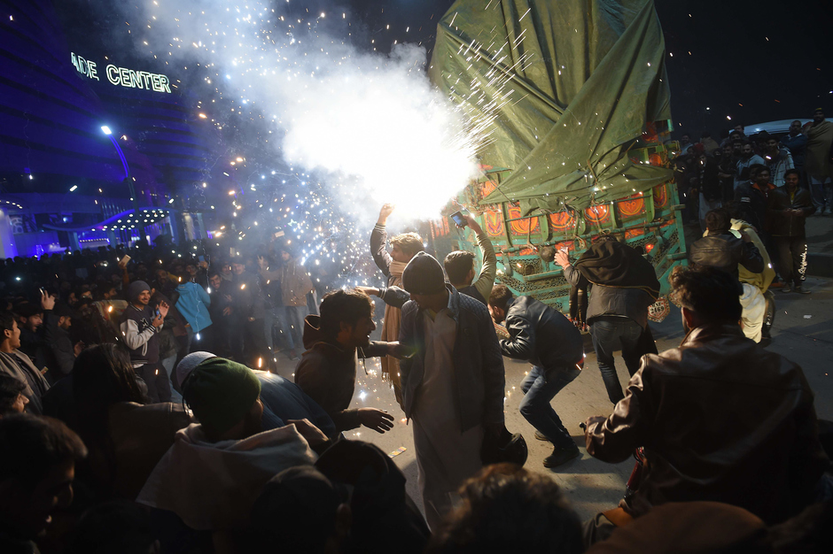Youth enjoy the firework display during the New Year celebrations in Rawalpindi. PHOTO: AFP