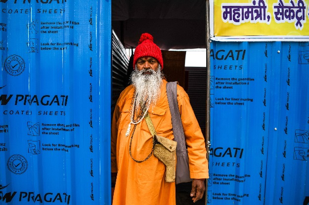 An Indian sadhu (Hindu holy man) stands at the entrance of his accommodation at the Kumbh Mela festival in Allahabad. PHOTO: AFP