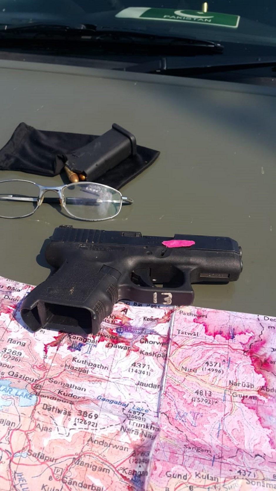 Gun, map recovered from downed Indian pilot. PHOTO: EXPRESS