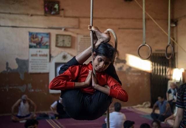 In this photo taken on February 15, 2019, a young visually impaired Indian gymnast performs a rope version of the Indian ancient sport Mallakhamb at the Shree Samartha Vyayam Mandir in Mumbai. - Some 100 competitors from 15 different countries take part in the Mallakhamb World Championships in India's financial capital of Mumbai on February 16 and 17. Mallakhamb is a gymnastics-like discipline that originated in western India in the 12th century and is often described as 