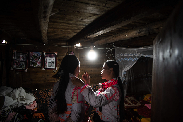 Two girls from the Long Horn Miao, a branch of the Miao ethnic minority group, preparing their make-up prior to taking part in the annual flower festival or 'Tiaohuajie' in the village of Longjia in China's Guizhou province. PHOTO: AFP