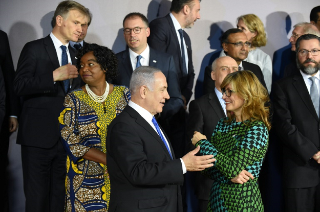 Netanyahu spoke with Bulgaria's Foreign Minister Ekaterina Zakharieva prior to a group photo during the conference in Warsaw. PHOTO: AFP