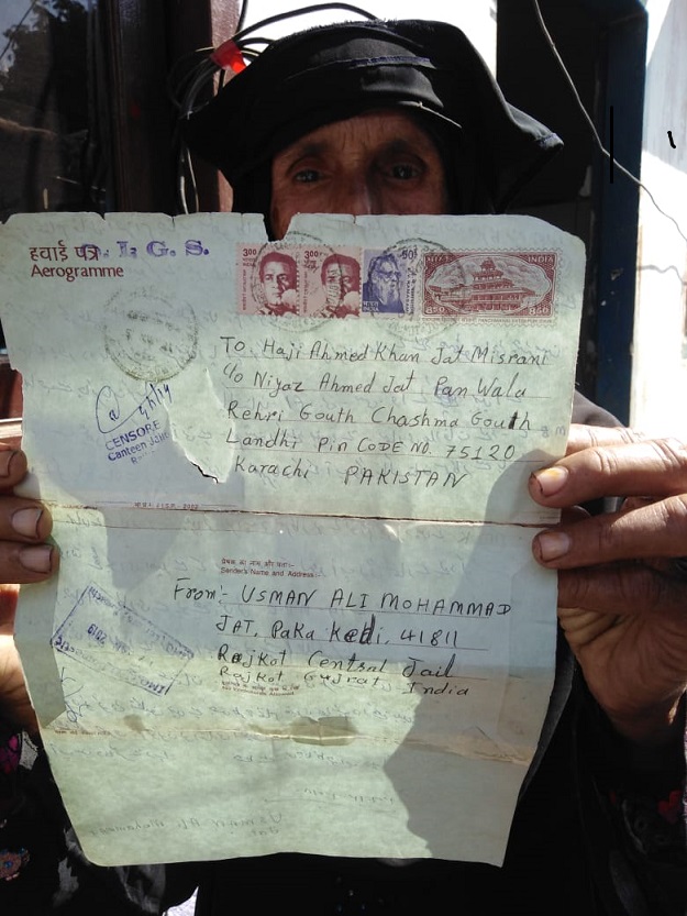 Woman holding letter sent by her brother (fisherman imprisoned in India). PHOTO: Express