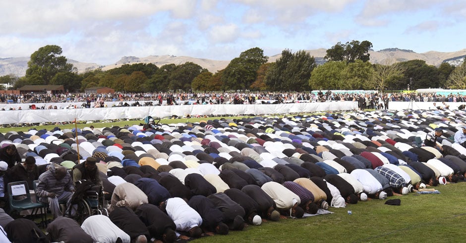 People pray during congregational Friday prayers and two minutes of silence for victims of the twin mosque massacre, at Hagley Park in Christchurch. PHOTO: AFP