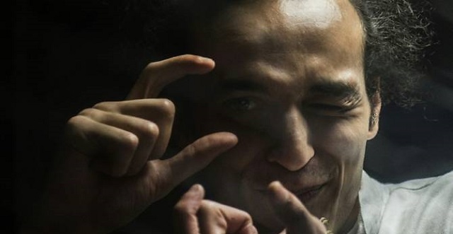 egyptian photographer mahmoud abu zeid known as shawkan gestures from inside a soundproof glass dock during his trial in cairo on august 9 2016 photo afp