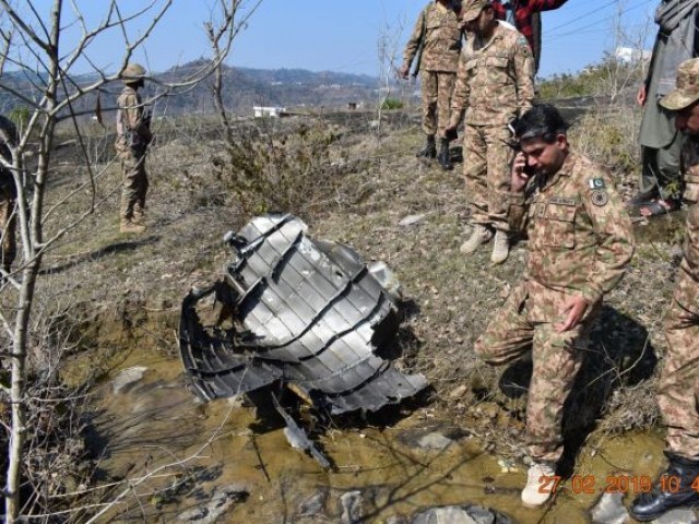 Pakistan Army inspects wreck of IAF aircraft. -EXPRESS