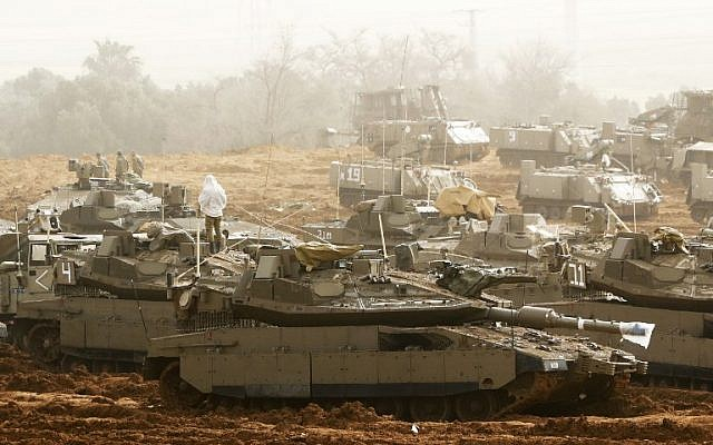 this picture taken on march 30 2019 shows israeli merkava main battle tanks stationed near the border with the gaza strip in southern israel photo afp