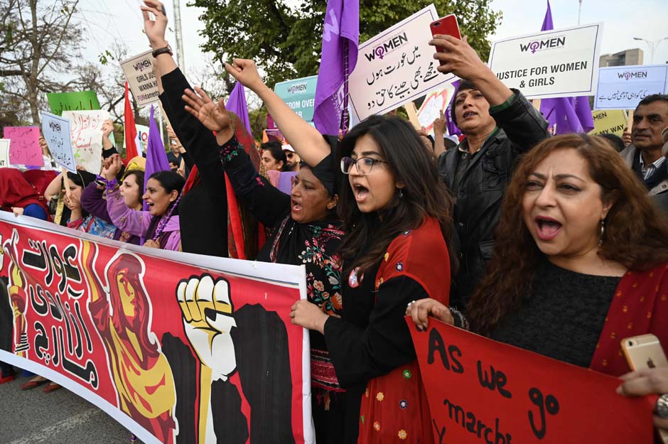 Pakistani civil society activists carry placard and shout slogans during a rally for women rights on International Women's Day in Islamabad. PHOTO: AFP