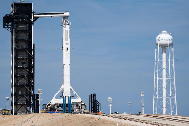 The SpaceX Falcon 9 rocket with the unmanned Crew Dragon capsule on its nose sits at Kennedy Space Center. PHOTO: AFP