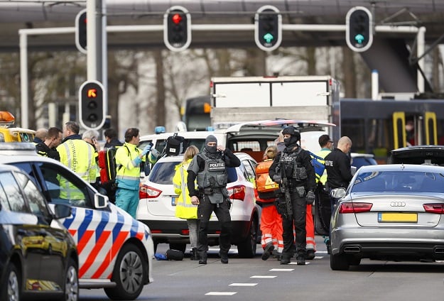 olice forces stand at the 24 Oktoberplace in Utrecht, on March 18, 2019 where a shooting took place. - Several people were wounded in a shooting on a tram in the Dutch city of Utrecht on March 18, police said, with local media reporting counter-terrorism police at the scene. 