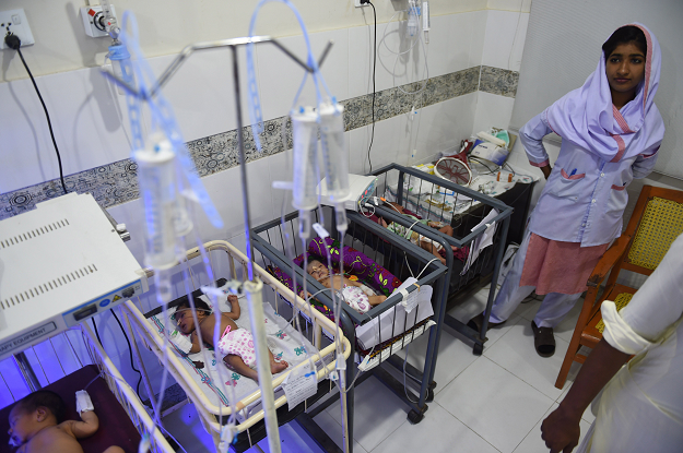 A medic takes care of children at Mithi Civil Hospital in Mithi. PHOTO: AFP