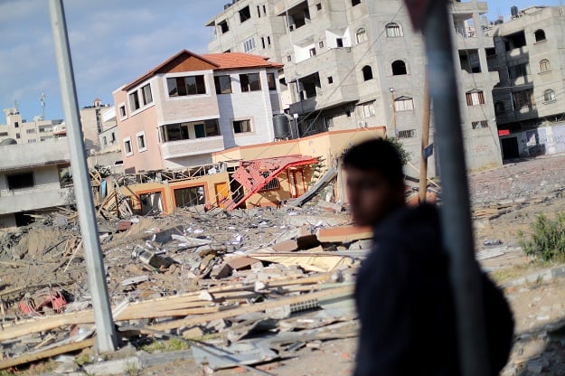 A Palestinian stands near the office of Hamas chief Ismail Haniyeh after it was destroyed by an Israeli air strike in Gaza City March 26, 2019. PHOTO: REUTERS