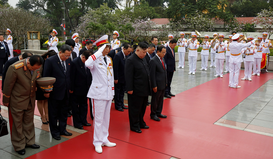 North Korea's leader Kim Jong Un (C) bows after laying a wreath at the War Heroes and Martyrs Monument in Hanoi on March 2, 2019. PHOTO: AFP