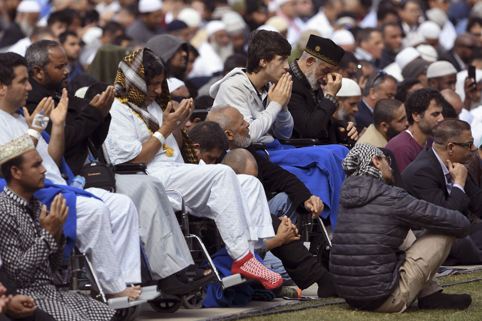 Injured people from the shootings pray during congregational Friday prayers and two minutes of silence for victims of the twin mosque massacre, at Hagley Park in Christchurch. PHOTO: AFP